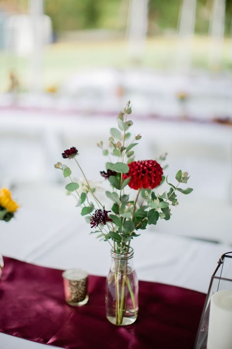 Bud Vases. Color Palette: Rich autumn hues, loads of sunflowers. Yellow, gold, red, burgundy, maroon, crimson, white, blush, peach. Featured Flowers: Sunflower, Rudbeckia, Dahlias, Scabiosa, Strawflower, Fern, Zinnia, Cosmos, Eucalyptus, Amaranth, Celosia, Lisianthus Local Flower Farms: Pisarcik Vendor Team: Floral & Event Design: Bramble & Blossom Photography: Kelsey Kradel Cake: Tasty Bakery Wedding Centerpieces With Bud Vases, Autumn Bud Vases, Fall Wedding Bud Vases, Dahlia Bud Vase, White Wedding Table Decor, Dahlia Centerpiece, Small Vases With Flowers, Zinnia Bouquet, Bud Vases Arrangements