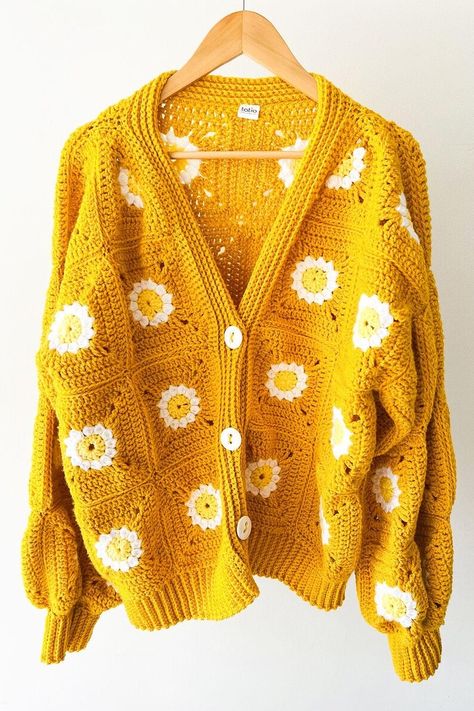 Front view of a mustard yellow crochet cardigan with granny squares and daisy patterns, featuring a cozy boho chic style. Yellow Granny Square, Crochet Sweater Pattern Easy, Granny Square Crochet Cardigan, Crochet Diy Tutorial, Crochet Sweater Design, Cotton Pants Women, Woolen Sweaters, Crochet Daisy, Square Crochet