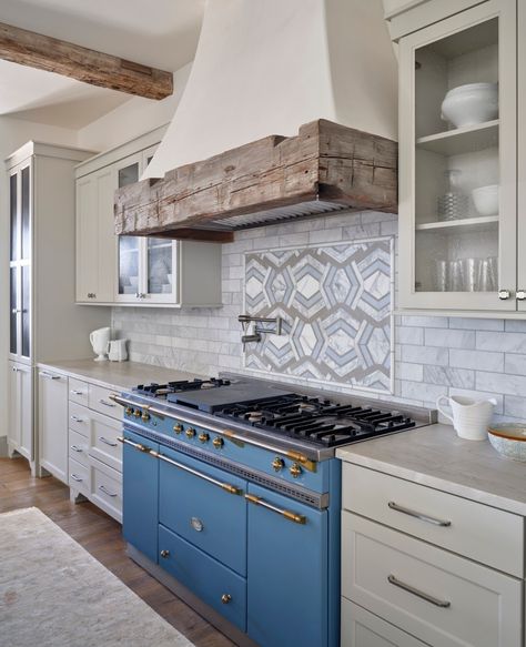 We love a fun pop of color! This gorgeous blue range complements the blue in the decorative tile behind the stove, and the natural wood from the range hood and ceiling beams help to balance out the room. Photographer: @andreacalo Builder: @maberycontracting Architect: #pollardhodgsonarchitects • • • #TexasInteriorDesign #HillCountryLiving #LuxuryLiving #KitchenGoals #DesignInspo #DonnaFiggDesign Blue Lacanche Range Kitchen, Tile Behind Range, Greece Inspired Home, Kitchen With Beams, Modern Spanish Farmhouse, Vent Hood Ideas, Spanish Farmhouse, Casita Ideas, Range Tile