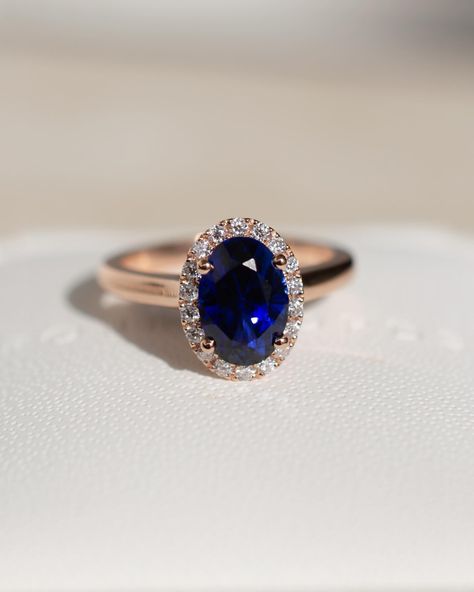 There’s something about that blue against the rose gold 💙 this regal engagement ring has a gorgeous blue sapphire centre, a bold halo, and a soft round profile rose gold band. Details: - 1ct oval blue sapphire - 18x round moissanites - 18k rose gold - 1.9mm wide shank #customengagementring #nz #aus #sapphireengagementring #bluesapphirering #bespokeengagementring Regal Engagement Rings, Princess Diana Ring, Engagement Ring Princess, Diana Ring, Blue Gemstone Ring, Blue Sapphire Engagement Ring, Engagement Rings Princess, Diamond Princess, Beach Shower