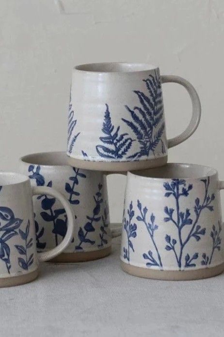 These stoneware mugs, featuring a hand stamped blue botanical pattern on a neutral background, are perfect for adding simple farmhouse charm to your morning coffee. 100% stoneware Sold individually- style will vary Measures 3.75"H x 4" Diameter (16oz) Each one will vary slightly in pattern and finish Cottage Mug, Farmhouse Tabletop, Mug Design Ideas, Vintage Inspired Home, Simple Farmhouse, Vintage Farmhouse Style, Make Do And Mend, Mug Ideas, Neutral Background