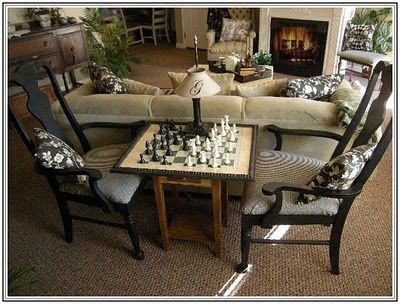 155 dream lane, chess table.  In family room. Chess Table And Chairs Living Rooms, Game Area In Family Room, Chess Nook Living Rooms, Chess Table Ideas, Chess Room Ideas, Chess Board In Living Room, Chess Set Decor Living Rooms, Living Room With Game Table, Chess Table In Living Room