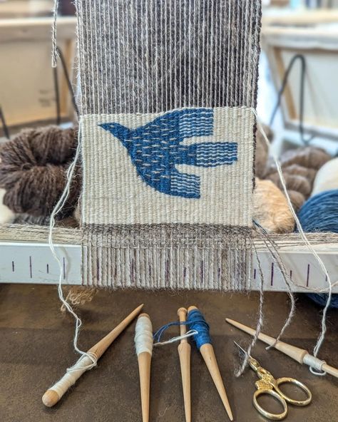 Demoing tapestry in the @jbfletcherstore museum today for the Columbia Basin culture tour! This piece is inspired by Swedish folk art. Handspun warp and weft, blue is indigo I dyed. . . . . #tapestry #tapestryweaving #wovenwallhanging #woventapestry #fibreart #fibreartist #weaving #handwoven #handweaving #weaversofinstagram #textileart #handwoventapestry #handspun #handspinning #handspunyarn #handmadeyarn #yarnlovers #yarnaddict #yarnobsessed #yarn #spinning #handmadehome #modernmaker #heri... Woven Coaster Pattern, Woven Projects Ideas, Homemade Weaving Loom, Yarn Weaving Wall Hanging, Weaving Rugs On A Loom, Hand Woven Tapestry, Free Weaving Patterns, Weaving Tapestry Patterns, Lap Loom Weaving Projects