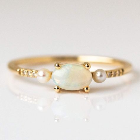 Opal luminescence, diamond sparkle, and pearly glow make up this solid gold ring from La Kaiser.  With a gorgeous vintage inspired design and a trio of trendy gems, this ring is equal parts modern and classic. To customize or order this ring in other sizes please reach out to concierge@localeclectic.com. Natural Austra Opal Pearl Ring, Pearl And Opal Ring, Opal And Pearl Ring, Unconventional Wedding Rings, Diamond Cuff Ring, Pink Wedding Rings, Ruby Wedding Band, V Necklace, Total Girl