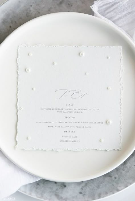 #wedluxe #wedluxemagazine #pearl #white #stationery #wedding #simple #elegant #menu #tablesetting Pearl Accent Wedding Decor, Wedding Pearl Veil, Pearl Wedding Signage, Pearls At Wedding, Pearl Core Wedding, Pearl Black And White Wedding, Pearl Place Cards, Pearl And Lace Wedding Theme, Pearl Inspired Wedding