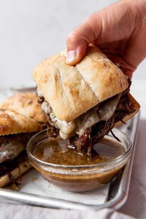 These toasty Slow Cooker French Dip Sandwiches are made with slow cooked roast beef served on crusty rolls with melty cheese and savory au jus. The prep is less than 15 minutes and then the crockpot does all the work for you. This slow cooker french dip sandwhich recipe is so good! | french dip sandwich crockpot | french dip sandwich instapot | french dip sandwich instant pot | french dip sandwich easy roast beef | french dip sandwich easy crock pot Slow Cooked Roast Beef, Slow Cooker French Dip Sandwiches, Slow Cooker French Dip, Recipes French, French Dip Sandwiches, Dip Sandwiches, French Dip Sandwich, French Dip, Chapati