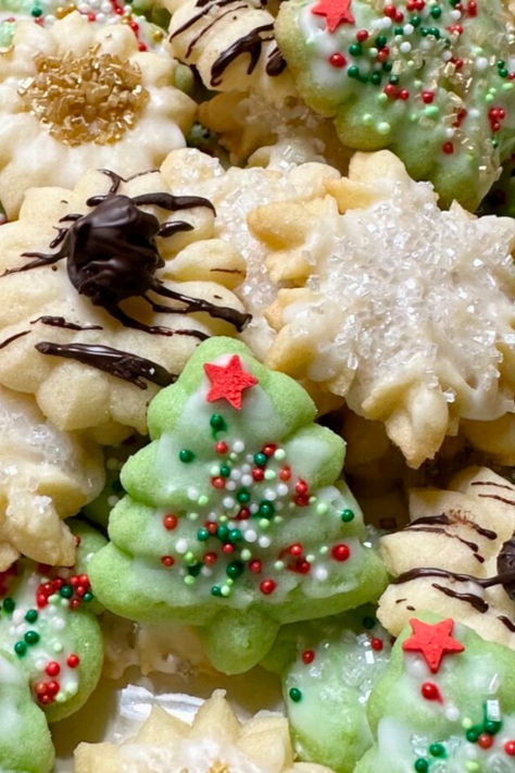 A plate of Spritz Christmas cookies. Brides Fingers Cookies, Chai Spritz Cookies, Dairy Free Spritz Cookies, How To Make Spritz Cookies, Pressed Cookies Christmas, Cookie Spritz Recipes, Jello Spritz Cookies, Eggnog Spritz Cookies, Small Batch Spritz Cookies