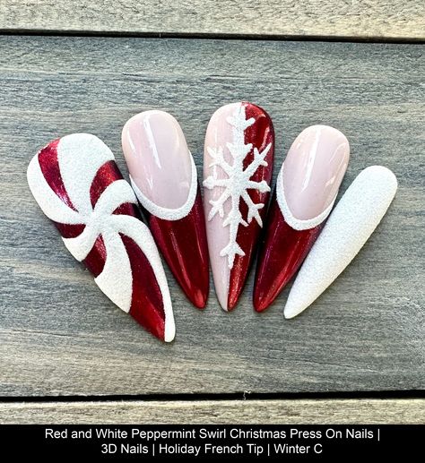 Dawn Witch Designs Unique, re-usable, hand painted, and made in Canada. These luxury press on nails are handmade using high quality gel polish and salon-grade materials.  ✨ RED PEPPERMINT SWIRL ✨  This manicure features red chrome tips and white sugared detailing on the peppermint swirl and snowflake. It's a showstopper! *The shape shown in the pictures is the LONG STILETTO *Colours may appear a little different due to your personal monitor setti Peppermint Acrylic Nails, Christmas Acrylic Nails Medium Length, Red Peppermint Nails, Red Christmas Tree Nails, Red White And Green Nails Christmas, Flannel Christmas Nails, Glamorous Christmas Nails, Christmas Acrylic Nails French Tips, Red Chrome Nails Designs Christmas