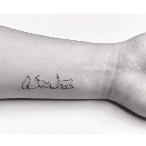 One line style cats tattooed on the wrist. Cat And Dog Tattoo, Cat Tattoo Simple, Black Cat Tattoos, Cat Tattoo Designs, Cute Tiny Tattoos, Line Art Tattoos, Subtle Tattoos, Time Tattoos, Elegant Tattoos