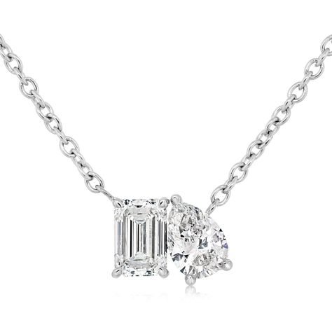 14K white gold diamond two stone diamond pendant from the Reis-Nichols Collection. The pendant features one emerald cut diamond and one pear shape diamond weighing .66 ctw. The necklace measures 16" in length. Emerald Cut Diamond, Pear Shaped Diamond, Emerald Cut Diamonds, Style Gift, Pear Shape, White Gold Diamonds, Emerald Cut, Diamond Pendant, Pear Shaped