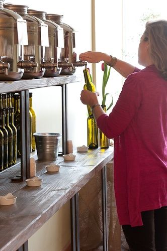 Olivette: EVOO Tasting Room & Retail in Darien — CT Bites Olive Oil Display Stand, Olive Oil Display, Olive Oil Tasting, Olive Oil Store, Flavored Vinegars, Bulk Store, Apothecary Decor, Before The New Year, Zero Waste Store