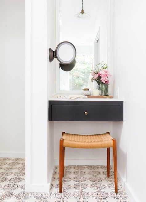 Gorgeous vanity nook features a black floating dressing table with white mirror above, and wall mount make-up mirror to the right, over a mid-century modern teak vanity stool atop hand painted terracotta floor tiles. Amber Interiors Bathroom, Vanity Nook, Bathroom With Makeup Vanity, Desks For Small Spaces, Bright Homes, Amber Interiors, Room Deco, Small Desk, Decorating Small Spaces