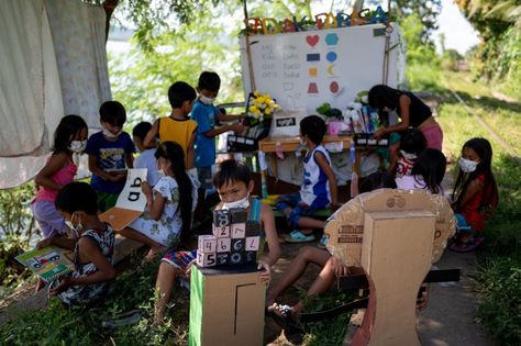 Student volunteers ride on their makeshift trolley which serves as a mobile library for children, in Tagkawayan, Quezon Province, Philippines, February 15, 2022. Picture taken February 15, 2022. © REUTERS/Lisa Marie David By Adrian Portugal A brightly decorated wooden trolley rumbles down a little-used rail track in the southern Philippines carrying four young teachers, two […] Education In The Philippines, Quezon Province, Wooden Trolley, 2022 Picture, Spelling Lessons, Daycare Classroom, Mobile Library, Teacher Photo, Body Drawing Tutorial