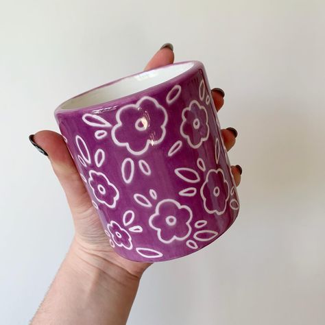 Purple plant pot with sgraffito simple florals 🌸✨💜 So many different ceramics available on my website now! Link in bio ✨💕 #art #artist #ceramics #pottery #painting #illustrator #ceramicstudio #potterytiktok #potterypainting #painter #potteryart #ceramicpainter #floral #bisqueware #glaze #houseplant #creative #smallbusiness #smallbusinessowner #smallartist #floral #plate #potterylove #decor #botanical #botanicalart #potteryprocess #potteryfeature #potteryistic #artgallery #handpainted Purple Pottery, Purple Plants, Pottery Design, Bio Art, Illustrators On Instagram, Ceramic Studio, Sgraffito, Pottery Painting, Ceramics Pottery