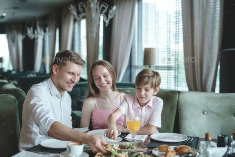 Happy family in a restaurant by AboutImages. Happy family with a child dining in a restaurant#restaurant, #family, #Happy, #dining Family At Restaurant Photography, Family Restaurant Photography, Sustained Investigation Ideas, Food Poses, Lifestyle Food Photography, Hotel Breakfast Buffet, Family Friendly Living Room, Sustained Investigation, Hotel Ads