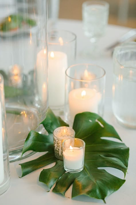 Tropical Candle Centerpieces Wedding, Tropical Diy Centerpieces, Tropical Engagement Party Ideas, Elegant Tropical Party Decor, Old Florida Party Theme, Cheap Tropical Centerpieces, Tropical Rehearsal Dinner Decorations, Tropical Leaf Centerpiece, Monstera Centerpiece Wedding