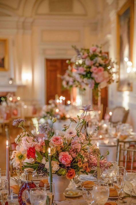 The flowers bloom in the dream  Step into a Fairytale: Long Island Castle Comes to Life with a Colorful Oil Painting-Style Floral Design for the Wedding Reception.   The intricate and delicate floral arrangements, created by Floraland, transformed the space into a magical wonderland that left guests in awe. The vibrant colors and artistic brushstrokes of the floral design perfectly complemented the regal beauty of the castle, creating a breathtakingly romantic atmosphere. Wedding Flowers Pink And Purple, Pink Purple Wedding Flowers Centerpiece Ideas, Castle Wedding Reception, Pink Floral Appliqué Wedding Gown, Island Castle, Pink Floral Applique Wedding Gown, Whimsical Pink Flower Arrangement, Easter Wedding, Colorful Oil Painting