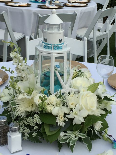 Lighthouse Wedding Centerpieces, Lighthouse Lantern Centerpiece, Diy Nautical Centerpieces, Lighthouse Floral Arrangements, Wedding Centerpieces Nautical, Lighthouse Theme Wedding, Beach Lantern Centerpieces, Nautical Centerpiece Ideas Wedding, Lighthouse Centerpiece Wedding