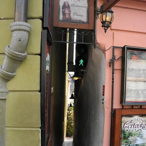 Prague’s Narrowest Street is So Narrow it Has Traffic Lights For Pedestrians Narrow Street, Scenic Travel, Charles Bridge, Traffic Lights, Street Names, World Photo, Traffic Light, Source Of Inspiration, Travel And Leisure