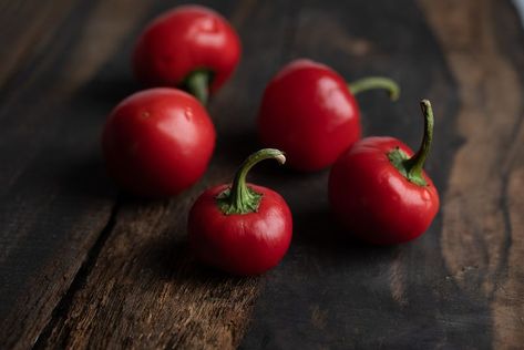 Cherry Bomb peppers Cherry Bomb Pepper, Cherry Bomb, Dark Background, Peppers, Food Photography, Good Food, Cherry, Stuffed Peppers, Fruit