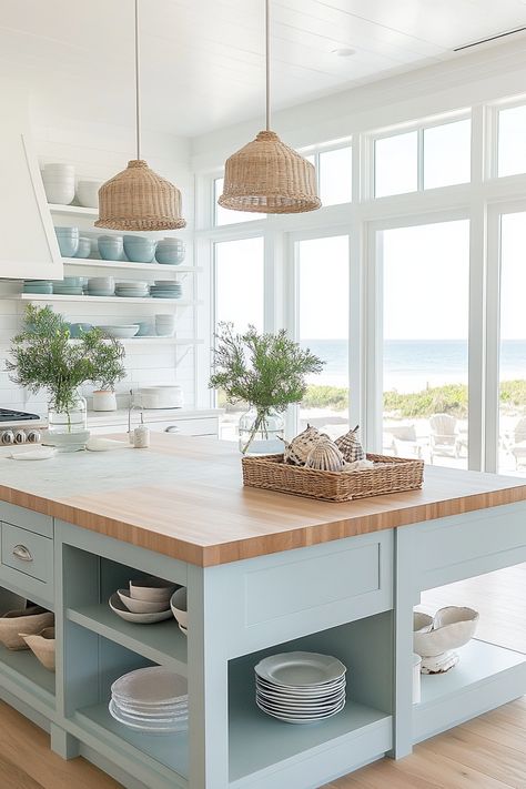 Transform your home with the latest kitchen design trends! This light and airy coastal kitchen showcases sleek open shelves, pastel blue cabinetry, and natural wood elements for a serene vibe. Perfect for a beach-inspired look. #KitchenDesign #HomeDecor #CoastalLiving Coastal Kitchen Cupboards, Big Coastal Kitchen, New England Beach House Kitchen, Coastal Interiors Design Kitchen, Coastal Modern Farmhouse Kitchen, Coastal Color Kitchen Cabinets, Modern Coastal Kitchen Table, Colorful Coastal Kitchen, Light Blue And Wood Kitchen