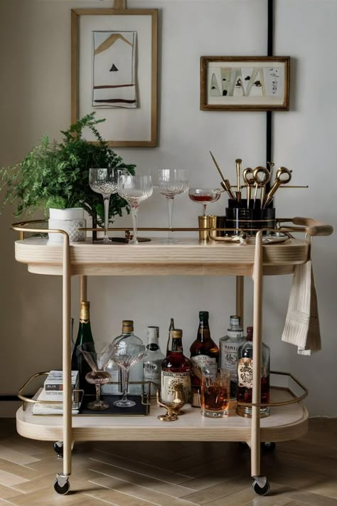 minimal japandi bar cart styling idea with wine glasses, decanters and plants for your living room decor and home mini bar 3 Shelf Bar Cart Styling, Drink Corner, House Bar Decor, Japandi Bar Cart, Cute Apartment Bar Carts, Bar Cabinet Styling Ideas, Coffee Bar Ideas Cart, Bar Table Decor Ideas, Help Yourself Bar