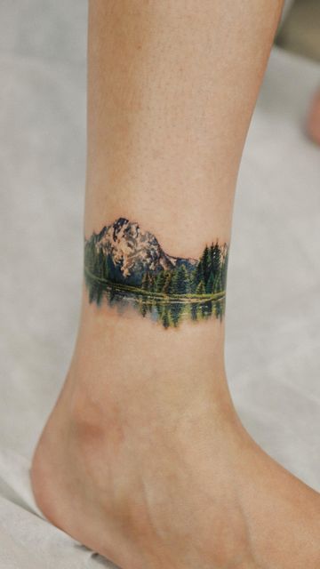 Mountain Range Ankle Tattoo, Mountain Tattoo Colorful, Mountain Tattoo Wrap Around, Pnw Inspired Tattoo, Watercolor Tattoo Mountain, Montani Semper Liberi Tattoo, Mountains And Water Tattoo, Colored Mountain Tattoo, Mountain Foot Tattoo