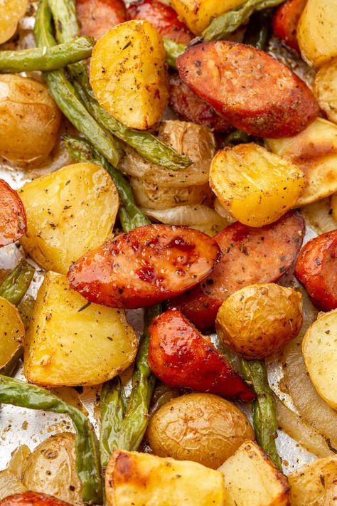 This flavorful one-pan meal featuring smoky andouille sausage, green beans, and potatoes is always a family favorite in my house. Roasted to perfection, this easy and delicious sheet pan recipe is perfect for a quick weeknight dinner or a casual gathering. It’s ready in just about 45 minutes! #glutenfree #recipe Sausage Green Beans And Potatoes, Sausage Potatoes Green Beans, Sausage Green Beans, Pan Green Beans, Smoked Sausage And Potato Recipe, Sausage And Green Beans, Andouille Sausage Recipes, Kielbasa And Potatoes, Sheet Pan Sausage