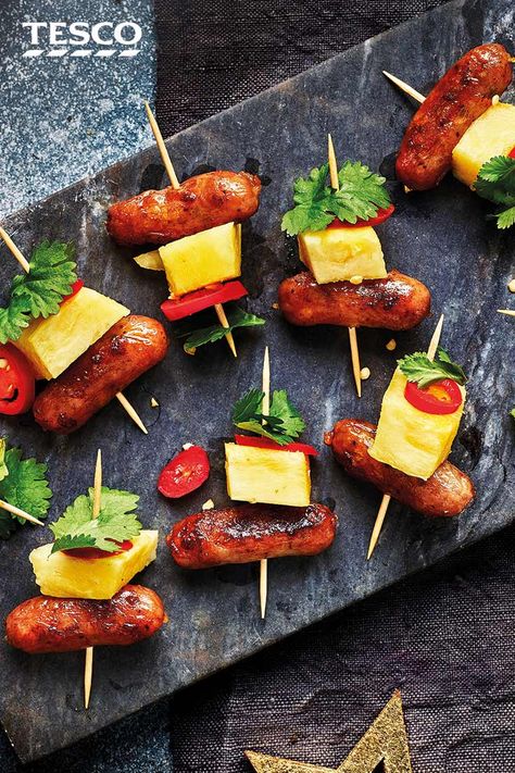 Layer up sticky honey glazed cocktail sausages with juicy pineapple, spicy chilli and coriander for these colourful Hawaiian skewers - a party-pleasing canapé. | Tesco Beach Party Foods, Hawaiian Skewers, Sausage And Pineapple, Cocktail Sausage Recipes, Pineapple Skewers, Beach Party Food, Christmas Dinner Sides, 31 Birthday, Sausage Appetizers