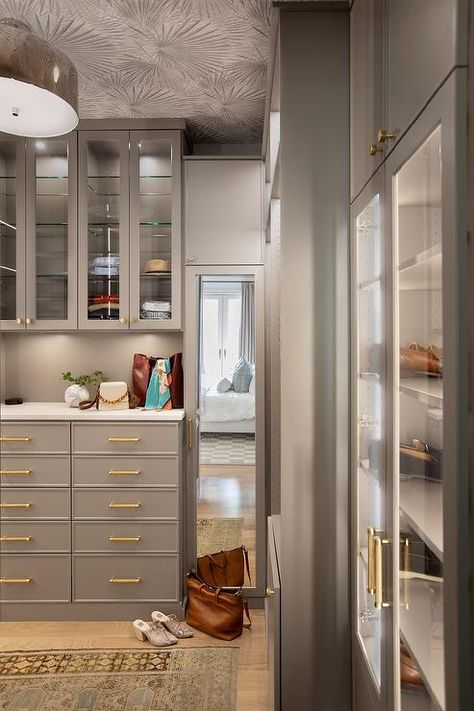 Custom gray closet features gray ceiling wallpaper, drawers with brass pulls, lighted shoe cabinets and a vintage rug. Wallpaper Drawers, Closet Ceiling, Gray Ceiling, Closet Corner, Closet Redesign, Gray Closet, Transitional Closet, Closet Wallpaper, Glam Closet