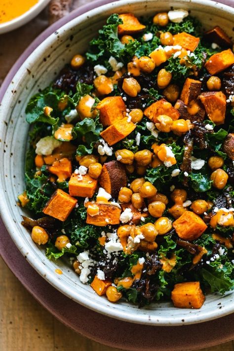 This Sweet Potato Kale Salad features roasted sweet potatoes, crispy chickpeas, caramelized onions, and a silky smooth roasted red pepper dressing! If you're at all bored of your salads lately, this one's for you. The sweet caramelized onions and tangy dressing really take it to the next level - it's downright addicting! It's hearty enough to be a main course, but is also wonderful with a piece of grilled salmon or chicken! #kalesalad #sweetpotato #chickpeas #glutenfree #veganfriendly Sweet Potato Red Onion, Roasted Chickpeas And Sweet Potatoes, Roasted Red Pepper Dressing, Red Pepper Dressing, Sweet Potato Kale Salad, Potato Kale Salad, How To Carmalize Onions, Roasted Sweet Potato Salad, Kale Feta