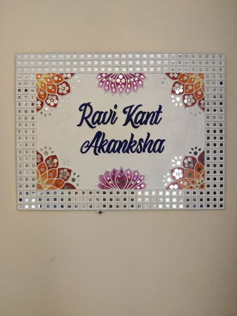 Motifs and mirrors are combined to make this beautiful customised handmade nameplate on 18"×24" board... Mirror Work On Mdf Board, Lippin Art Name Plate, Name Plate Lippan Art Ideas, Wooden Name Plates For Home Diy, Handmade Nameplate Ideas, Lippan Art Mirror Name Plate, Lippan Art Nameplate, Mosaic Nameplate, Lipan Art Nameplate