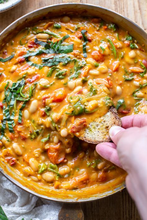 The comforting flavors of this Creamy Vegan Tomato White Bean Stew make the perfect easy lunch or dinner. This dairy-free & plant-based recipe is packed with wholesome ingredients, like protein-packed white beans, cherry tomatoes, and nutrient-dense greens. Learn how to make this easy and satisfying vegan stew in just 25 minutes. Beans Tomato Recipe, Bean Based Meals Healthy, Few Ingredient Meals Vegetarian, Dairy Free Soups And Stews, Vegan Dense Bean Salad, Healthy Plant Based Dinner, Easy Healthy Dinner Dairy Free, White Bean Recipes Vegetarian, Vegetarian Meals With Protein