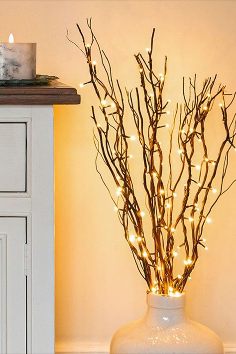 Create a warm and inviting ambiance in your living room with these enchanting indoor lighting ideas! From soft candles that twinkle like stars to elegant fairy lights that cast a gentle glow, discover the perfect ways to infuse coziness into your space ✨ Fall Garland Diy, Twigs Decor, Lighted Tree Branches, Cosy Decor, Vase With Branches, Twig Lights, Fairy Lights Decor, Snow Effect, Fall Living Room Decor