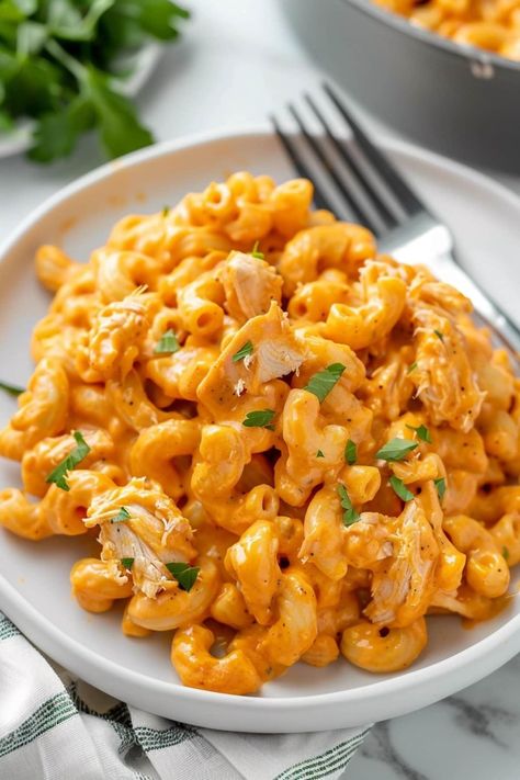 Buffalo chicken mac and cheese is the ultimate homemade comfort food. From the tender pasta and buffalo chicken to the cheesy sauce, it's drool-worthy. Cheesy Buffalo Chicken Pasta, Mac And Cheese Easy Recipe, Creamy Buffalo Chicken Mac And Cheese, Mac And Cheese Recipe Buffalo Chicken, Buffalo Chicken Mac And Cheese With Popcorn Chicken, Buffalo Mac N Cheese Recipe, Buffalo Chicken Macaroni And Cheese, Mac And Cheese Easy, Buffalo Chicken Mac And Cheese