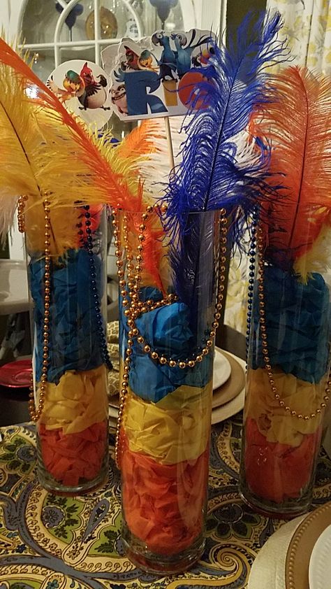 Disney Rio-themed centerpieces. Just tissue paper, large vases, feathers and pics on sticks. Rio Carnival Centerpieces, Rio Hoco Theme, Rio Themed Party, Rio Themed Birthday Party, Rio Birthday Party Ideas, Rio Carnival Theme Party, Rio Birthday Parties, Carnival Centerpieces, Carnival Rio