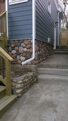 River Rock (Color: Old Chief) by The Exterior Company in C… | Flickr Exterior Rock Siding, River Rock Wall, Outdoor Wall Paint, Rock Siding, River House Ideas, Rock Foundation, Stucco Finishes, Siding Ideas, White Siding