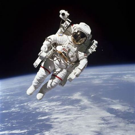 Image: This Feb. 7, 1984 photo made available by NASA shows astronaut Bruce McCandless II, participating in a spacewalk a few meters away from the cabin of the Earth-orbiting space shuttle Challenger, using a nitrogen-propelled Manned Maneuvering Unit. Background Stars, Space Shuttle Challenger, Nasa Photos, Nasa Missions, Sky Stars, Nasa Astronauts, Space Photos, Space Pictures, Apollo 11