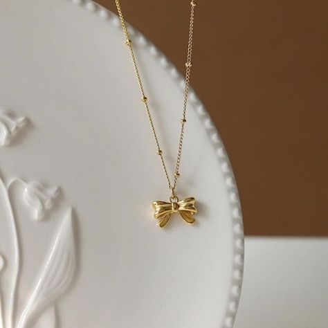 Elevate your style with these trendy gold necklaces! 🌟 Perfect for everyday wear or as a thoughtful gift for someone special. Find your favorite design now! #GoldNecklace #DaintyJewelry #TrendyStyle ✨ Jewelry Gold Necklace, Dainty Gold Jewelry, Bow Pendant, Tiny Pendant, Knotted Necklace, Necklace Trendy, Grad Ideas, Tiny Bow, Bow Necklace