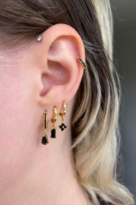 This beautiful gold and black ear curation is perfect for anyone with multiple piercings / those looking for piercing ideas. These earring stacks are perfect for anyone looking for helix piercing jewellery, 3 lobe piercing ideas, upper lobe piercings, double lobe piercings and daith piercings. These earrings are 925 sterling silver with a gold coating and have zircon stones. We ship worldwide! They are the perfect ear stack for summer Triple Lobe Earrings Set, Ear Lobe Piercings Triple, Earring Stack 3 Lobe, 4 Lobe Piercings Ideas, Black And Gold Ear Curation, Multiple Lobe Piercings, Black And Silver Earring Stack, Three Lobe Piercings, 3 Lobe Piercings Ideas