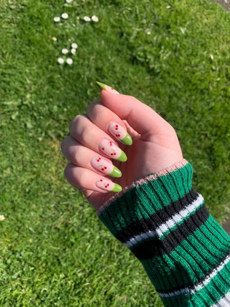 Cherry gel nails with green french tips with grass in the background Green Nails With Cherries, Green Cherry Nails, Cherry Gel Nails, Green French Tips, Nails With Green, Olive Nails, Green French, Green Cherries, Cherry Nails