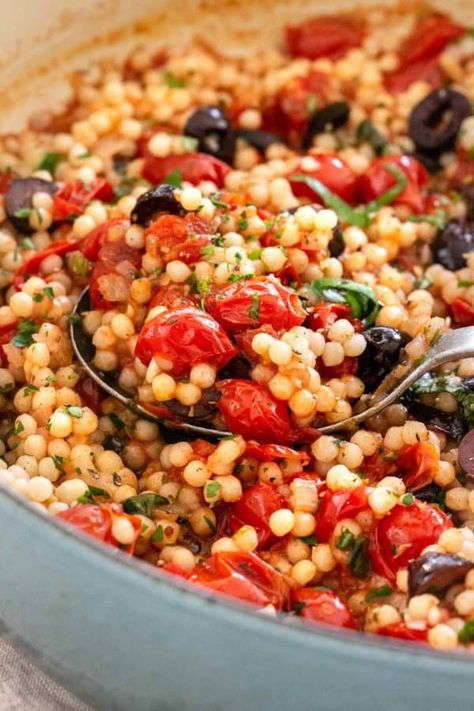 Israeli couscous with tomato and olives is a flavorful side dish that\'s tossed in a Mediterranean-inspired sweet and tangy cherry tomato sauce. #couscous #mediterranean #healthy Egyptian Couscous Recipes, Couscous Sauce, Leftover Couscous, Couscous Mediterranean, Fish Side Dishes, Olive Tomato, Tomatoe Sauce, Mediterranean Couscous, Olive Sauce