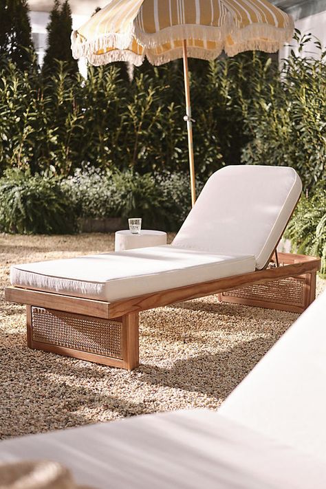 Coated in a UV- and water-resistant fabric, this lounge chaise was made for dreamy warm-weather days. A soft cushioned seat rests atop a natural teak wood base, finished with intricate rattan-esque paneling. For ordering assistance and more, please contact us For aesthetic advice and tips to help decorate your space, enjoy our complimentary home styling services | Merit Chaise Lounge by Anthropologie in Beige Chez Lounge, Lounge Chaise, Teak Chaise Lounge, Useful Ideas, Pool Chairs, Pool Lounger, Natural Teak Wood, Outdoor Chaise Lounge Chair, Outdoor Lounge Chair