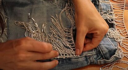 This is a guide to adding rhinestone fringe to clothes. Learn how to attach rhinestone trim to fabric to make sparkly shorts, a dress, and a cold-shoulder top, with this easy tutorial. Fringe Rhinestone Jeans, Add Rhinestones To Shirt, Diy Rhinestone Fringe Jean Shorts, Diy Rhinestone Jean Shorts, Rhinestone Fringe Shorts Diy, Diy Rhinestone Fringe Top, Diy Rhinestone Shirt Ideas, Diy Western Fringe Shirt, How To Rhinestone A Shirt