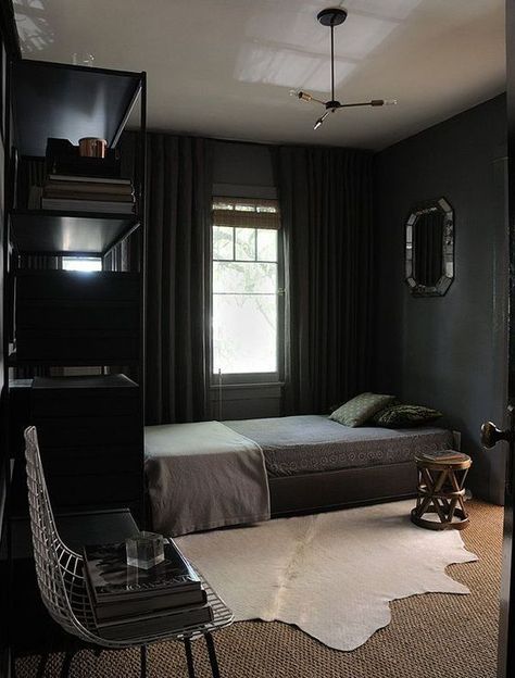 a dark vintage bedroom with black walls, black furniture and curtains, a wooden stool and a mirror on the wall Modern Mens Bedroom, Dark Room Decor, Man Bedroom, Cozy Small Bedrooms, Mens Bedroom Decor, Dark Bedroom, Small Bedroom Designs, Mens Bedroom, Bedroom Setup