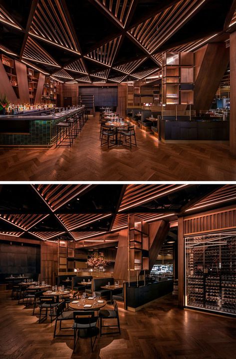 This modern restaurant's distinctive and massive structural joists divide the bar area from the main dining room. These angled columns& inspired the bar’s geometrical millwork and its triangular patterned wood trellis ceiling. #RestaurantDesign #ModernRestaurant #RestaurantInterior Bar Ceiling Lights, Celing Roof Design For Restaurant, Triangular Ceiling Design, Back Bar Design Restaurant Modern, Restaurant Ceiling Design Modern, Bar Ceiling Design, Cafe Ceiling Design, Restaurant Ceiling Design, Trellis Ceiling