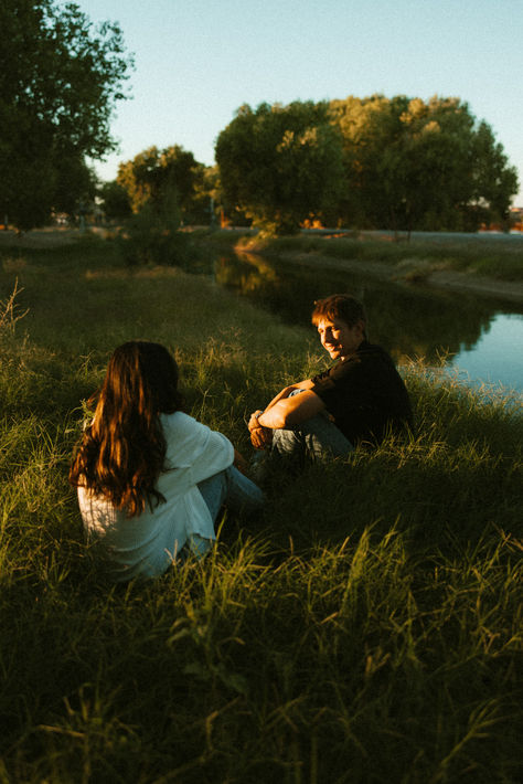 an sunny sunset engagement session in the green grass and trees next to a small river and Arizona. best poses for couples and engagement photography Love Photography Poses, Couple On Grass Aesthetic, Aesthetic Photos For Couples, Couple Poses With Tree, Couple Portrait Photography Poses, Two Couples Friends, Couple In Nature Aesthetic, Green Couple Aesthetic, Legal Photoshoot