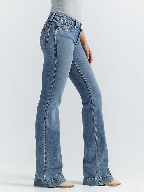 THE TROUSER: THE ULTIMATE IN WOMEN'S RETRO® JEANSLike all Wrangler Retro® jeans, our Mae wide-leg trouser jean is marked by its Western authenticity, making it a go-to style for cowgirls everywhere. With its contour waist and mid-rise fit, these women's trouser jeans are made to fit comfortably while they flatter all your curves. With more room at the knee and a gradual opening down the leg, the Mae wide-leg trouser gives you the room you need to stay active and in style. Women Boot Outfits, 1960s Jeans Women, Wrangler Trouser Jeans Outfit, Wrangler Retro Jeans Women, Wrangler Bell Bottom Jeans, Womens Fall Fashion 2024 Casual, Vintage Jeans Women, Cute Bootcut Jeans, Wrangler Flare Jeans