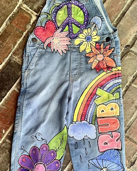 Been busy. I want to get all my orders finished before the 15th. Here is a new painted overalls design for a new customer in Rhode Island! #artistsofinstagram #painted #painted #overalls #paintedoveralls #painted #denim #painteddenim #painteddenimjeans #kids #kidsfashion #boutique #boutiqueshopping #boutiquestyle #boutiquefashion #boutiqueclothing #kidsboutique #kidsboutiqueclothing #kidsboutiques #kidsboutiqueuagirl #hippy #hippylife #hippystyle #hippychick #hippyvibes #hippyart #hippylove ... Custom Overalls, Hippie Overalls, Painting On Denim, Colored Mushrooms, Flowers And Rainbows, Painted Overalls, Bohemian Studio, Long Overalls, Toddler Birthday Party