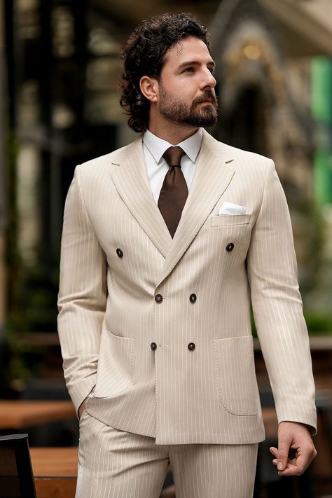 Experience a fresh take on power dressing with this beige striped suit. The structured double-breasted silhouette flatters the form, while the delicate stripe pattern adds a sleek, sophisticated touch to your look.  #beigesuit #stripedtailoring #modernfashion #elegantstyle #tailoredlook #professionalwear #chicensemble #sophisticatedstyle #fashionforward #stylishsuit Linen Wedding Suit, Double Breasted Suit Men, Bow Tie Suit, Modern Fit Suit, Suit Stores, Suit Styles, Slim Fit Suit Men, Striped Suit, Christmas Suit